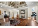 Spacious living room featuring a fireplace, hardwood floors, and elegant decor at 7025 Kettering Ln, Suwanee, GA 30024