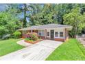 Attractive brick home with a spacious driveway and landscaped front yard at 3170 Bellgreen Way, Decatur, GA 30032