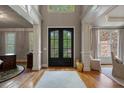 Inviting foyer with hardwood floors, grand entrance, and decorative details at 4250 Old Oak Trce, Cumming, GA 30041