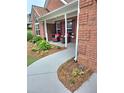 Inviting front porch with lush landscaping and comfortable seating, perfect for relaxing outdoors at 1382 Fountain Lakes Drive Dr, Lawrenceville, GA 30043
