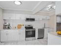 A modern kitchen featuring sleek white cabinets, stainless steel appliances, and elegant countertops at 3210 Quincetree Lane Ln, Decatur, GA 30034