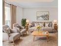 Bright living room featuring neutral decor, stylish seating, a large window, and decorative accents at 3210 Quincetree Lane Ln, Decatur, GA 30034
