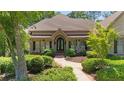 Charming home featuring a manicured front yard, a brick walkway, and an inviting porch at 10630 N Edgewater Pl, Johns Creek, GA 30097