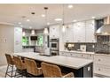 Bright kitchen featuring an island with seating, stainless steel appliances, and pendant lighting at 2786 Overlook Ne Dr, Atlanta, GA 30345