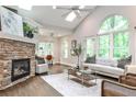 Cozy living room with stone fireplace, vaulted ceiling, large windows, and modern furnishings at 2786 Overlook Ne Dr, Atlanta, GA 30345