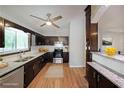 Well-lit kitchen featuring dark cabinetry, stainless steel appliances, granite countertops, and modern fixtures at 4191 Alaina Cir, Austell, GA 30106