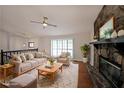 Bright living room with a stone fireplace, hardwood floors, and neutral furniture arrangement for relaxation at 4191 Alaina Cir, Austell, GA 30106