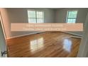 Bright bedroom featuring gleaming hardwood floors and natural light from two windows at 4191 Alaina Circle Cir, Austell, GA 30106