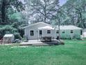 Home's backyard deck offers an ideal outdoor dining space at 543 S Holly Springs Rd, Woodstock, GA 30188
