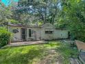 Lush backyard featuring a patio area and ample green space, ideal for outdoor relaxation and entertaining at 6385 Highway 92, Fairburn, GA 30213