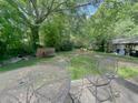 Spacious backyard with patio furniture and expansive green space perfect for activities and outdoor enjoyment at 6385 Highway 92, Fairburn, GA 30213