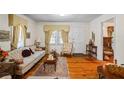 Bright and airy living room with hardwood floors, large windows, and neutral decor at 954 Bryant Sw St, Conyers, GA 30012