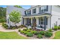 Beautiful home exterior with a inviting covered front porch and well-maintained landscaping at 1865 Henley Way, Alpharetta, GA 30009