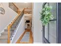 Inviting entryway features hardwood floors, staircase, and a view into the living room with a fireplace at 5355 Wyntree Ct, Peachtree Corners, GA 30071