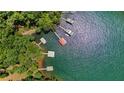 Aerial shot showcasing the waterfront property, docks, and lush surroundings at 7875 Robin Rd, Cumming, GA 30041