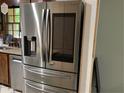 Stainless steel Samsung refrigerator with built-in screen and multiple pull out drawers in modern kitchen at 170 Beatrice St, Dallas, GA 30157
