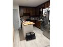 A view of the kitchen with dark cabinets and stainless steel appliances at 170 Beatrice St, Dallas, GA 30157