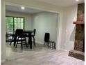 Open-concept living room with stone fireplace and sliding glass doors at 170 Beatrice St, Dallas, GA 30157