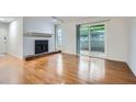 Bright living room featuring a fireplace, hardwood floors, and sliding glass door to outdoor space at 2901 Lenox Rd # 702, Atlanta, GA 30324
