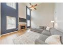 Bright living room with a soaring ceiling, a brick fireplace, and a large gray sectional sofa at 3816 Harris Nw Blvd, Kennesaw, GA 30144
