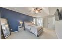Spacious main bedroom with a tray ceiling, blue accent wall, and neutral furnishings at 3816 Harris Nw Blvd, Kennesaw, GA 30144