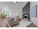 Bright living room featuring a fireplace, hardwood floors, and a view to the dining area at 2701 Windsor Nw Ct, Kennesaw, GA 30144