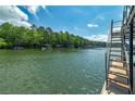 Lake view from the dock, showing a metal staircase that goes into the water at 2825 Lake Ct, Cumming, GA 30041