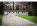 Classic ranch home with a bright turquoise door, long driveway and detached garage at 3893 Bonnie Se Ln, Atlanta, GA 30354