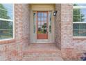 Close-up of a brick home's front door with glass panels and sidelights for a welcoming entrance at 764 Morganton Dr, Johns Creek, GA 30024