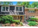 Attractive townhome with brick and siding, showcasing a well-maintained front yard with lush greenery at 2505 Northlake Court Northeast, Atlanta, GA 30345