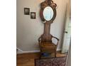 Antique wooden hall tree with a mirror, coat hooks, and a built-in seat, adding vintage charm at 2505 Northlake Court Northeast, Atlanta, GA 30345