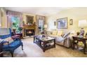 Cozy living room with a fireplace, comfortable seating, and natural light from large windows at 2505 Northlake Court Northeast, Atlanta, GA 30345