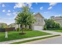 Beautiful two-story home with a brick facade, mature tree, and well-kept lawn at 4020 Huron Dr, Cumming, GA 30028
