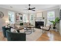 Bright living room featuring hardwood floors, multiple windows, stylish furnishings, and a cozy fireplace at 683 Terry Se St, Atlanta, GA 30315
