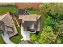 Aerial view of a well-maintained home with lush backyard landscaping, a neighboring house, and mature trees at 525 Wallis Farm Ln, Marietta, GA 30064