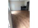 Open-concept dining area featuring wood floors and adjacent kitchen at 1151 Rankin St # 21A, Stone Mountain, GA 30083