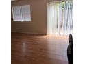 Bright living room featuring wood floors, sliding glass doors, and modern blinds at 1151 Rankin St # 21A, Stone Mountain, GA 30083