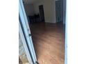 View from doorway of living area with wood floors, adjacent to a dining space and kitchen at 1151 Rankin St # 21A, Stone Mountain, GA 30083