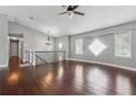 Open living room with hardwood floors and modern light fixture at 185 Hickory View Dr, Lawrenceville, GA 30046
