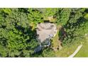 Expansive aerial view of home surrounded by dense trees with stone patio at 1323 Frey Lake Ct, Kennesaw, GA 30144