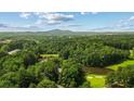 Scenic aerial view of community featuring lush greenery and mountain views at 1323 Frey Lake Ct, Kennesaw, GA 30144