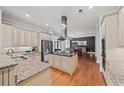 Modern kitchen with stainless steel appliances, granite countertops, and center island at 1323 Frey Lake Ct, Kennesaw, GA 30144