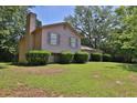 Charming two-story home with a well-manicured lawn and lush landscaping at 3429 Timbercreek Dr, Lawrenceville, GA 30044