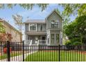 Stylish two-story home featuring a fenced yard and a cozy front porch at 907 Edgewood Ave Ne, Atlanta, GA 30307