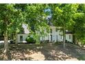 Stunning home featuring a white stucco exterior, black-framed windows and lush landscaping at 410 Glenmont Ct, Atlanta, GA 30350