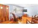 Cozy living room with hardwood floors, shuttered windows, and blue walls at 701 Rosedale Se Dr, Smyrna, GA 30082