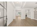 Spacious entryway featuring wood floors, white walls, and an open floor plan with views into the living spaces at 1619 Tielman Way, Snellville, GA 30078