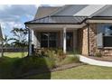 Detailed view of a home's stone facade, covered entryway, and manicured landscaping at 1619 Tielman Way, Snellville, GA 30078