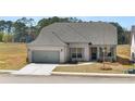 Charming single-story home with gray brick, gray shutters, and a well-manicured lawn at 1619 Tielman Way, Snellville, GA 30078