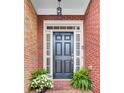 Welcoming front entrance with a classic black door, sidelights, and decorative plants at 195 Mystic Ct, Atlanta, GA 30342